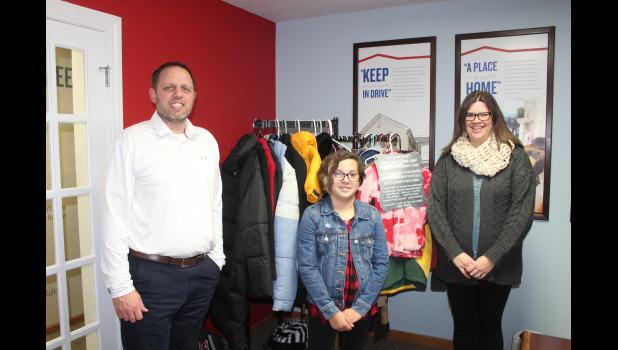 From left, Jeremy Haldeman, Izzy Garcia and Kali Scholze are pictured with the coat rack located inside Haldeman’s office, American Family Insurance in Tomah. Herald photo by Nicole Vik.